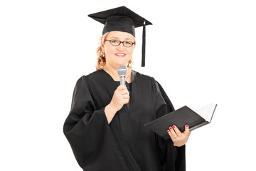 Mature woman in a gown speaking on microphone