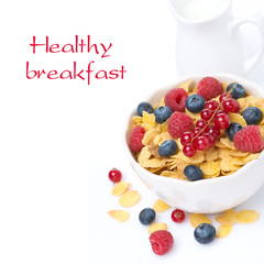 bowl of cornflakes with fresh berries and milk, isolated