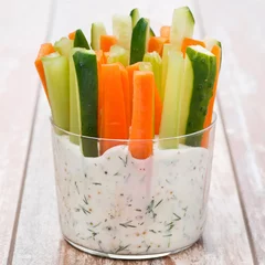Foto op Plexiglas fresh vegetables in a yoghurt sauce in a glass on wooden table © cook_inspire