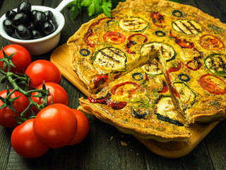 Quiche with grilled zucchini, tomato, red pepper and olives