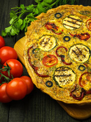 Quiche with grilled zucchini, tomato, red pepper and olives