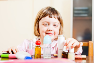Child with cosmetic products