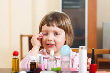 three year old child  painted cosmetics