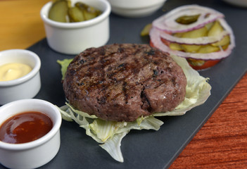 Open burger with lettuce leaves