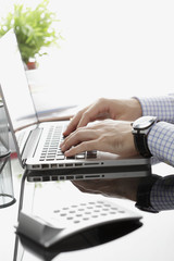 Close-up of businessman working on laptop