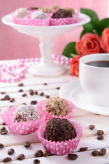 Set of chocolate candies on table on pink background