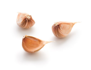 Garlic cloves on white background