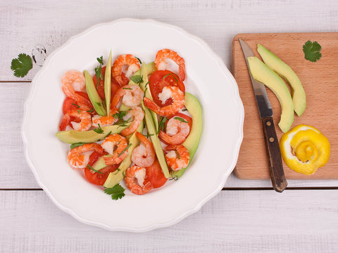 Shrimps, Avocado and Tomatoes Salad on a white plate