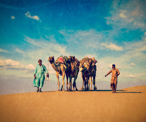 Two cameleers in dunes of Thar deser
