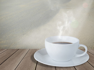 White coffee cup on wood board with white sand beach background