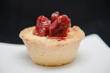 close-up of a tiny tart with strawberry on top