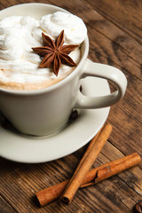 Delicious cup of coffee in a rustic background.