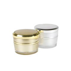 gold and silver container of cream