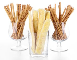Bread sticks in glasses isolated on white
