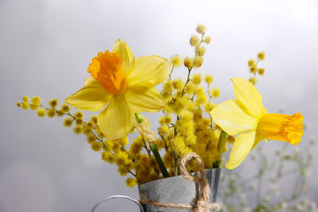 Beautiful spring flowers in vase on wooden table