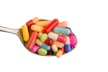 Viele Tabletten auf Löffel
