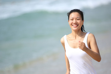 Fototapeta na wymiar fitness young woman jogging at beach