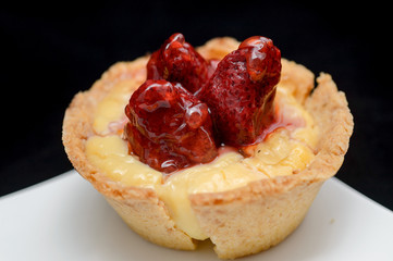 close-up of a tiny tart with strawberry on top