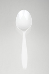 Plastic spoon on grey background