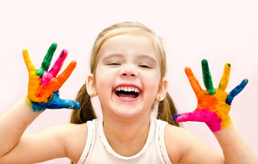 Happy little girl with hands in paint