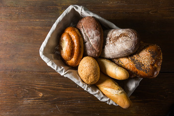 Photo of the assorted bread in wooden basket