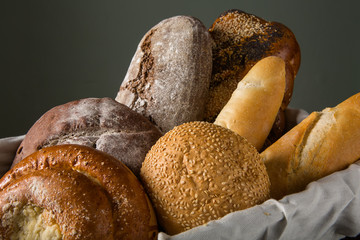 Photo of the assorted bread in wooden basket