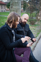 two bearded modern man working on tablet