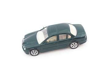 miniature green toy car on white background