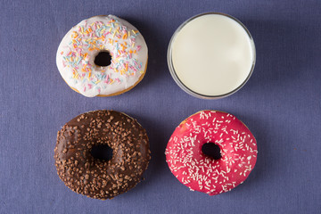 Donut with milk at violet background