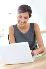 Beautiful businesswoman in office working on laptop