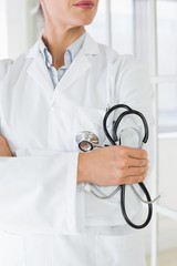 Mid section of a female doctor with stethoscope in hospital