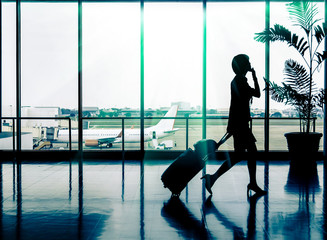 Business woman at Airport - Silhouette of a passenger