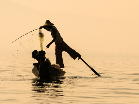 Inle Lake Myanmar - Traditional burmese fisherman balancing on t - Powered by Adobe