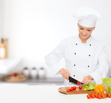 Smiling Female Chef Chopping Vagetables