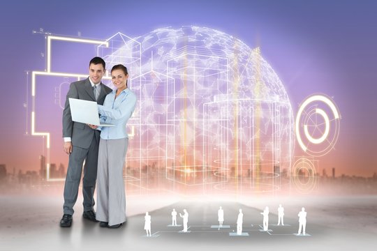 Happy business team using laptop with interface - Powered by Adobe