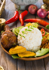 indonesian fried chicken rice on traditional background
