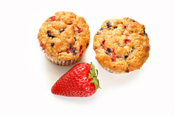Two Berry Muffins with a Fresh Strawberry