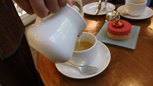 Waitress Pours Tea into Cup
