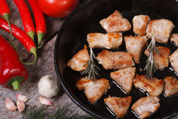 Pieces of grilled meat in a pan close-up. view from above.