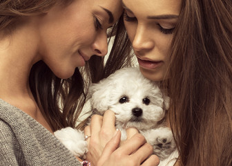 Portrait of young women with cute puppy