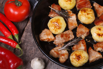 grilled meat and new potatoes in a pan view from above