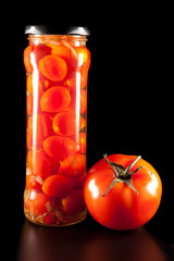 canned tomatoes in glass jars