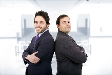 Two Businessman posing back to back together