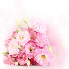 Fototapeta na wymiar Bouquet of eustoma flowers on bright background
