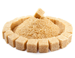 Sugar cube on a heap of granulated sugar