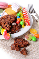 Different sweets on plate on table close-up