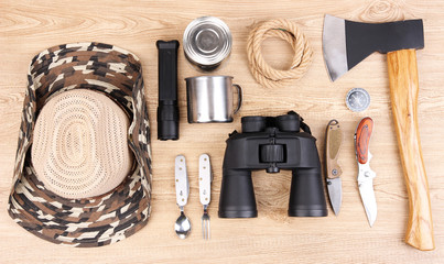 Equipment for trekking on wooden background