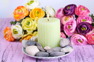 Fototapeta na wymiar Composition with spa stones, candle and flowers