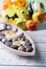 Composition with spa stones, candles  and flowers