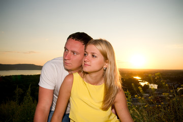 Loving couple at sunset in summer